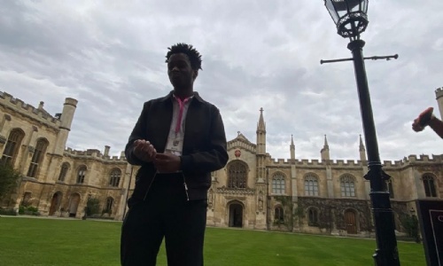 Perrez in front of the Corpus Christi college